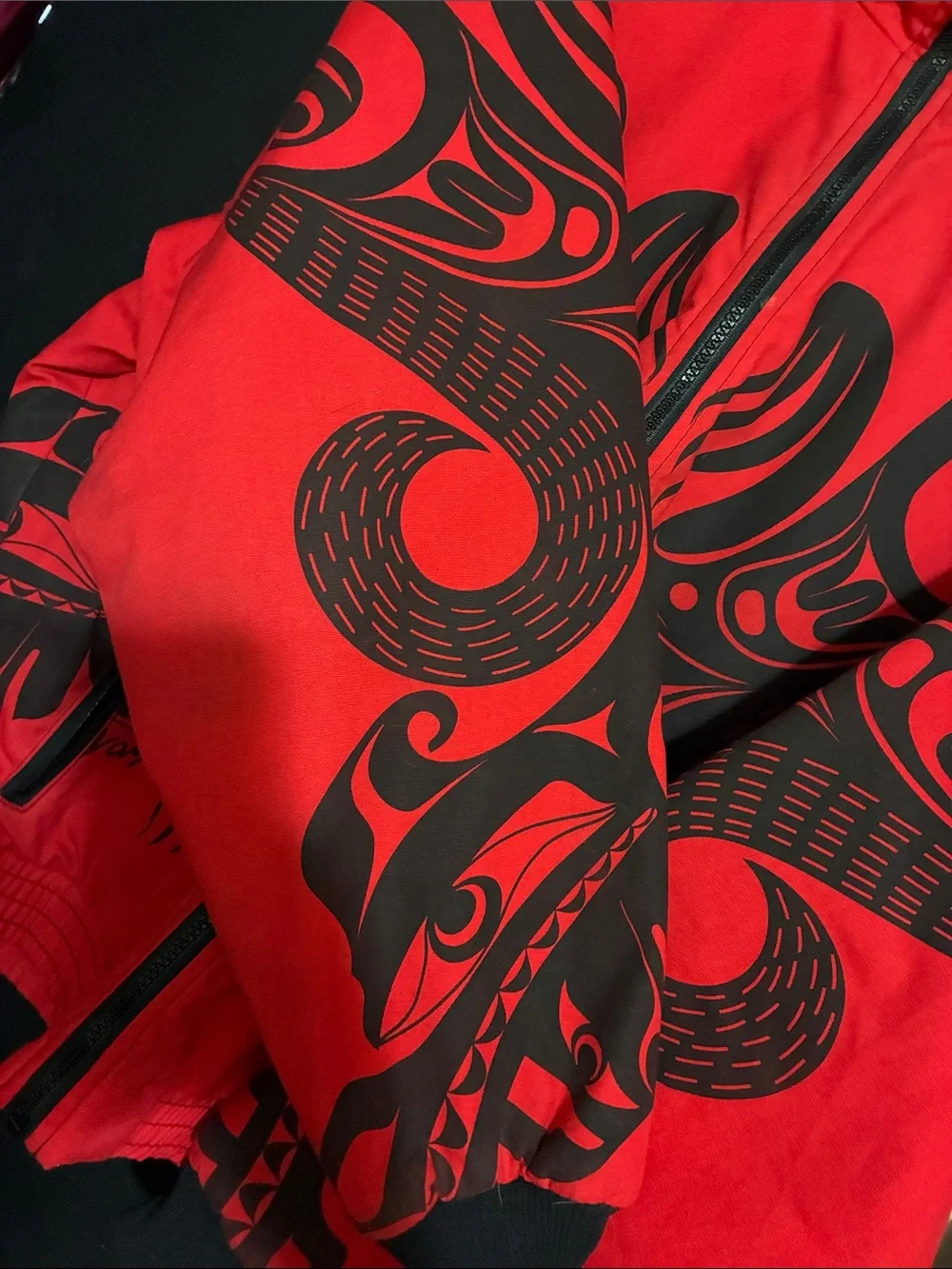 Red Puffer Jacket with Black Graphic Detailing